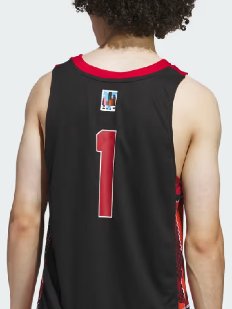 A person wearing a black basketball jersey with the number 1 printed on the back, standing against a plain white background.