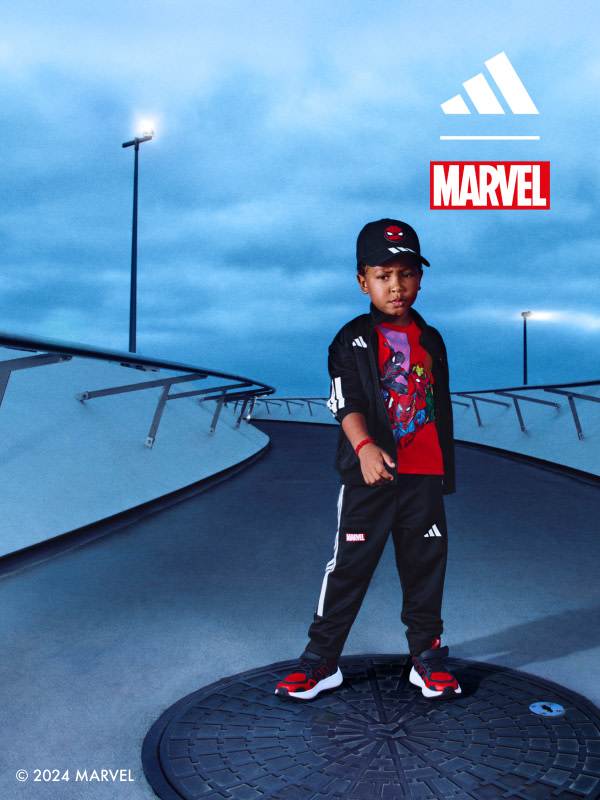 One child standing on a bridge wearing the adidas | Marvel collection