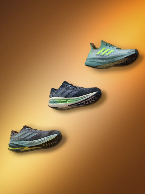 Image of Ultraboost, Supernova and Adistar shoes on orange background. 