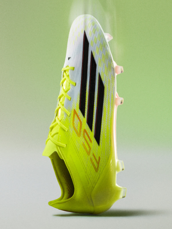 This image depicts a lime green and white football boot balancing vertically on its heel against a faded lime green and white background.