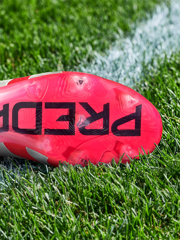 An outsole of an adidas football boot made to be played on firm ground