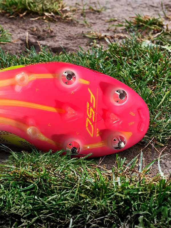 An outsole of an adidas football boot made to be played on soft ground