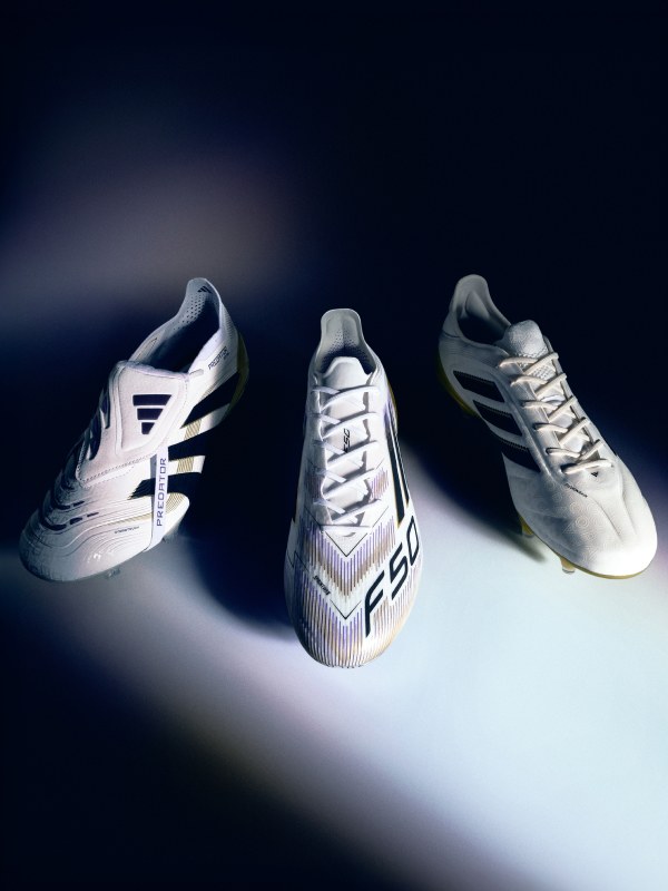 Three pairs of white and black soccer boots with intricate designs and patterns are displayed against a dark background, creating a striking and visually appealing composition.