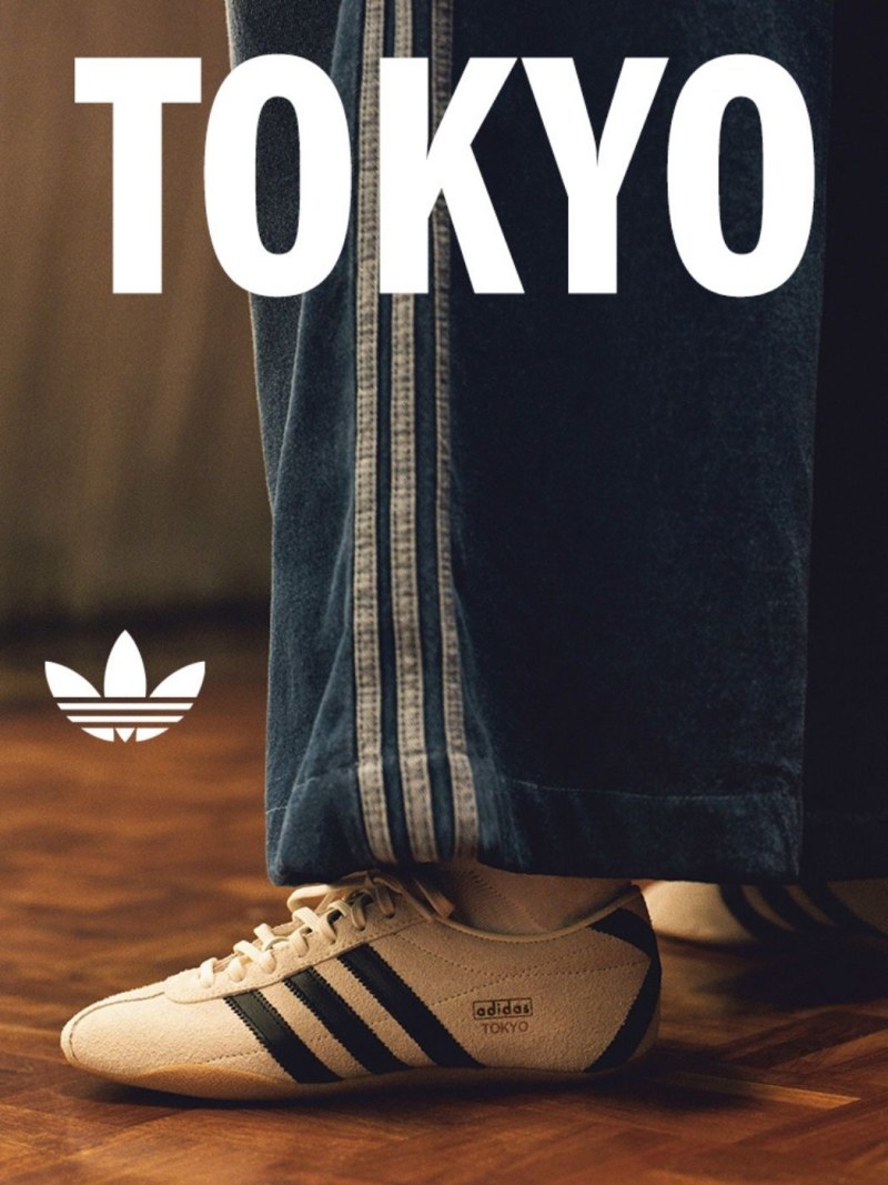 The image shows a pair of Adidas sneakers on the floor, with the word "TOKYO" prominently displayed above them.