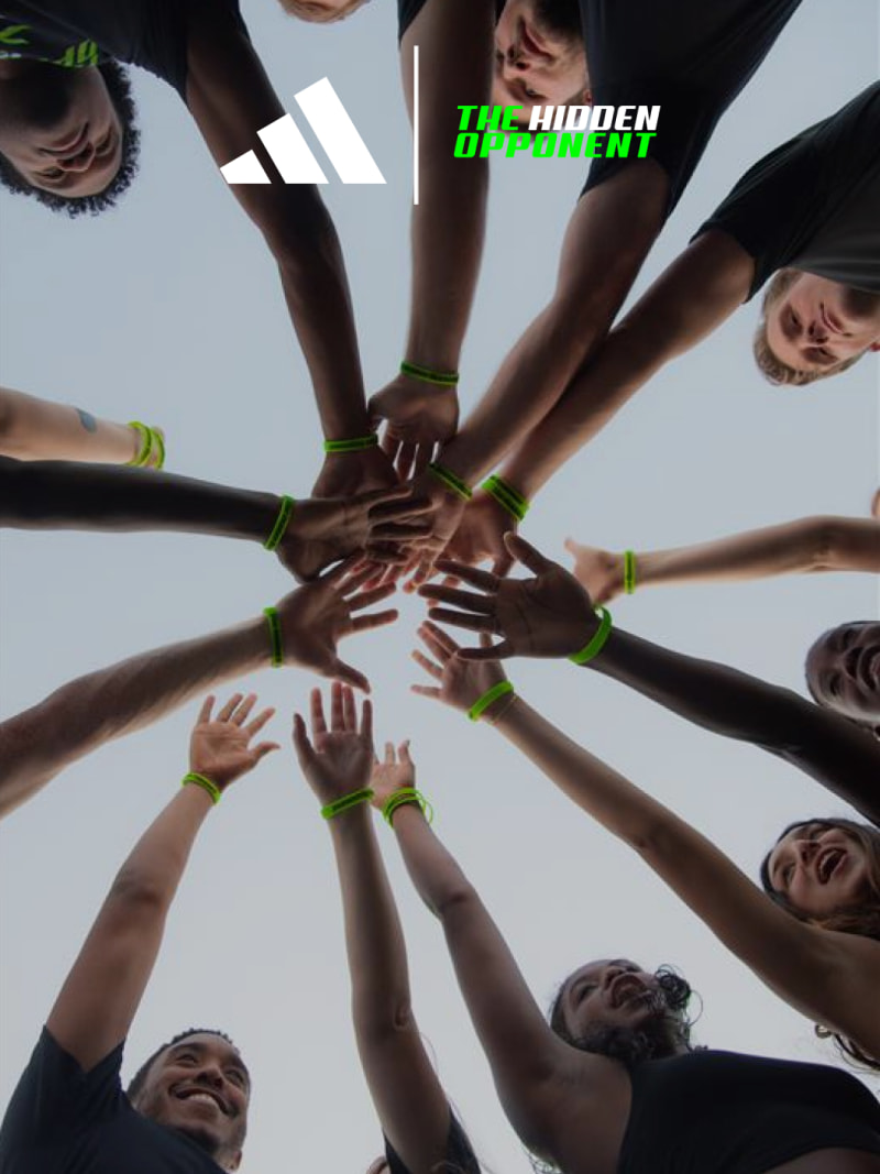 A group of people, diverse in appearance, are standing in a circle with their hands joined together, conveying a sense of unity and collaboration.