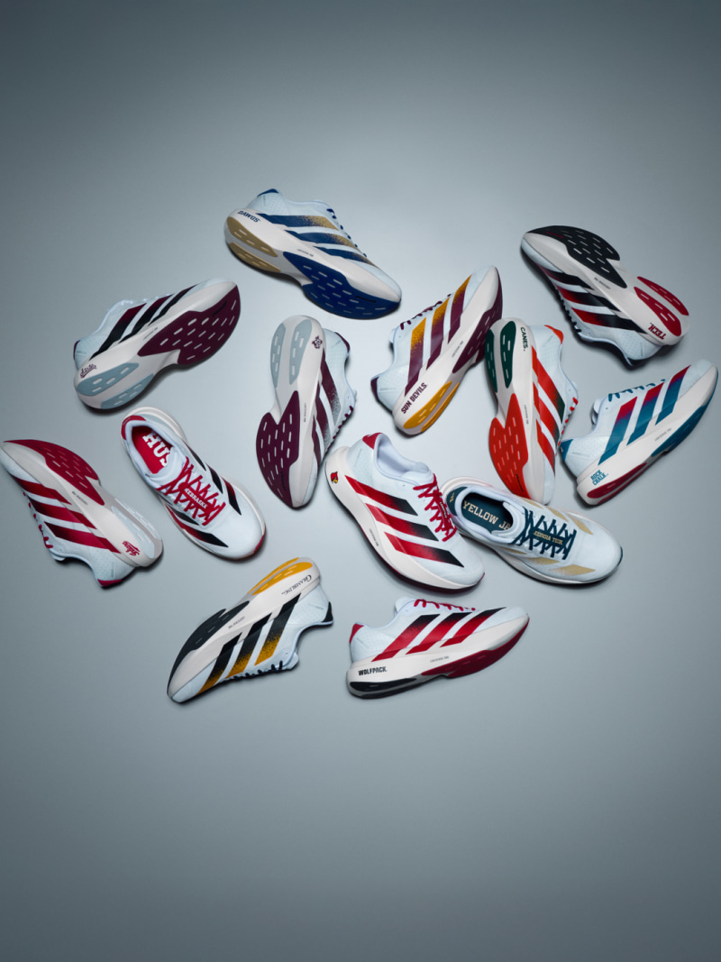 A collection of colorful, stylized sneakers or athletic shoes in various designs and patterns, arranged against a plain gray background.