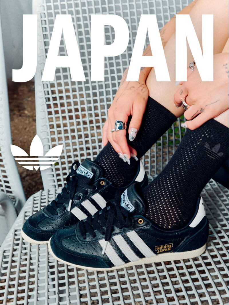 The image features a pair of black and white Adidas sneakers with the word "JAPAN" prominently displayed in the background.