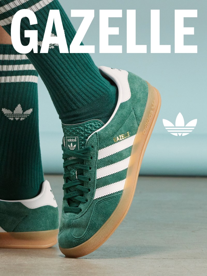 The image shows a pair of green Adidas Gazelle sneakers with white stripes against a background of green and white striped patterns.