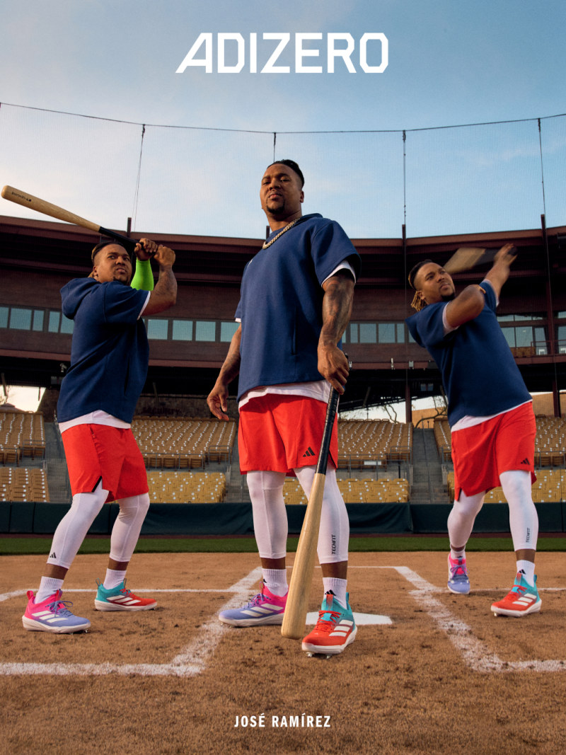 The image shows a group of three people in athletic clothing standing on a baseball field, with the word "ADIZERO" prominently displayed in the background.