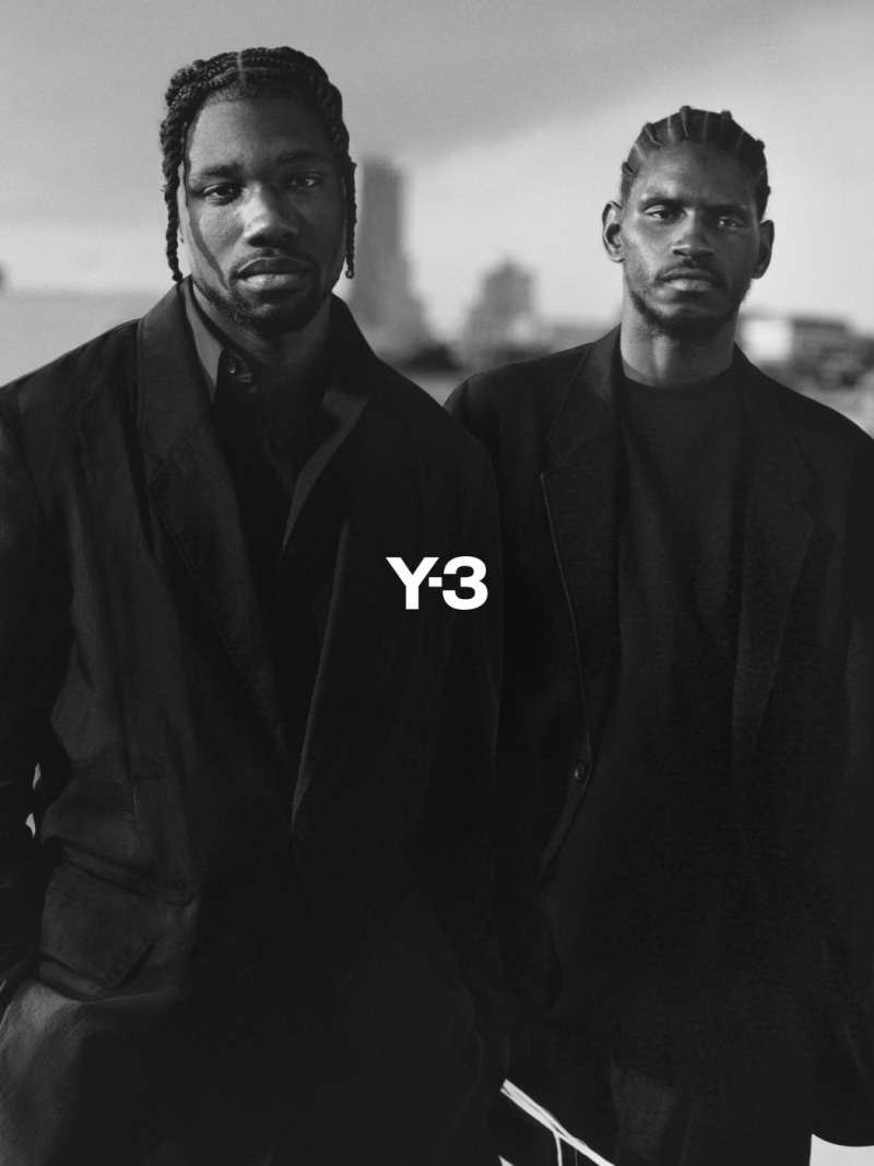 A$AP Nast and Noah Lyles stand on an LA rooftop in a black-and-white photo, dressed in adidas Y-3 and gazing intently into the camera.