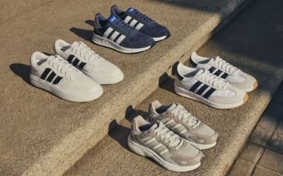 The image shows several pairs of Adidas sneakers in different colors, including white, navy blue, and gray, arranged on a carpeted floor.