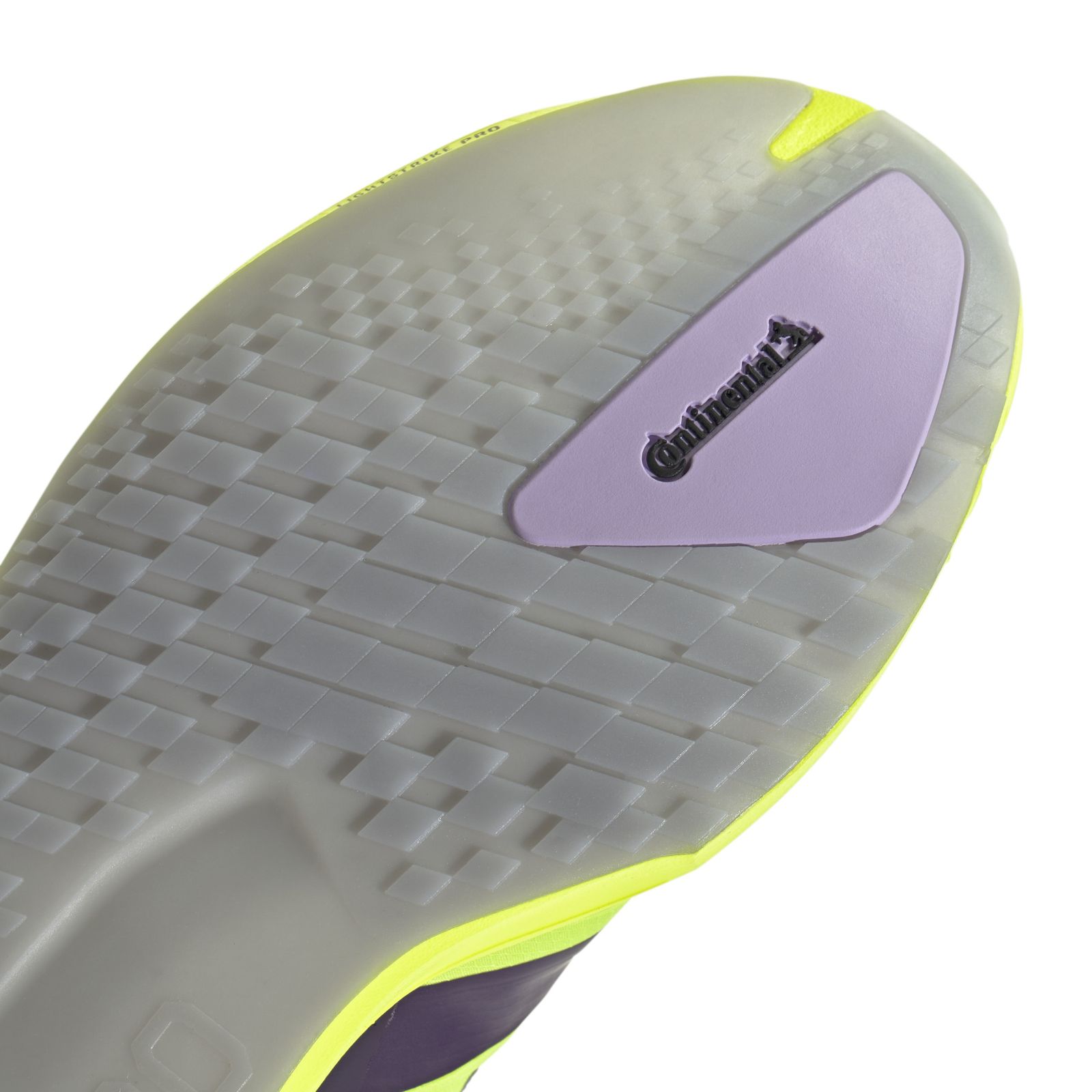 A close-up view of a gray and yellow athletic shoe with a textured sole and a purple accent on the side.