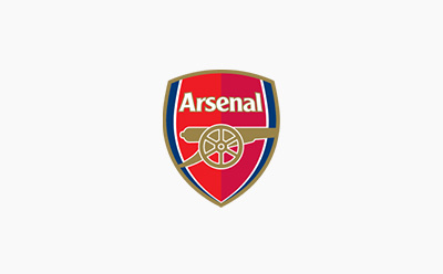 The image depicts the Arsenal football club's iconic crest, featuring the club's name and a cannon symbol against a red and blue background.
