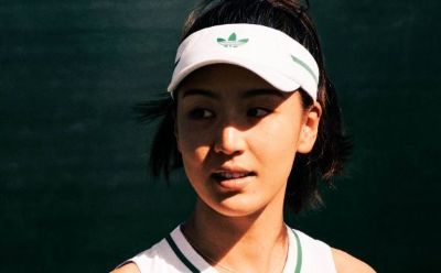 A person wearing an Adidas cap and looking directly at the camera against a dark background.