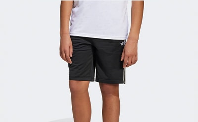 The image shows a person wearing a white t-shirt and black shorts with white stripes on the sides.