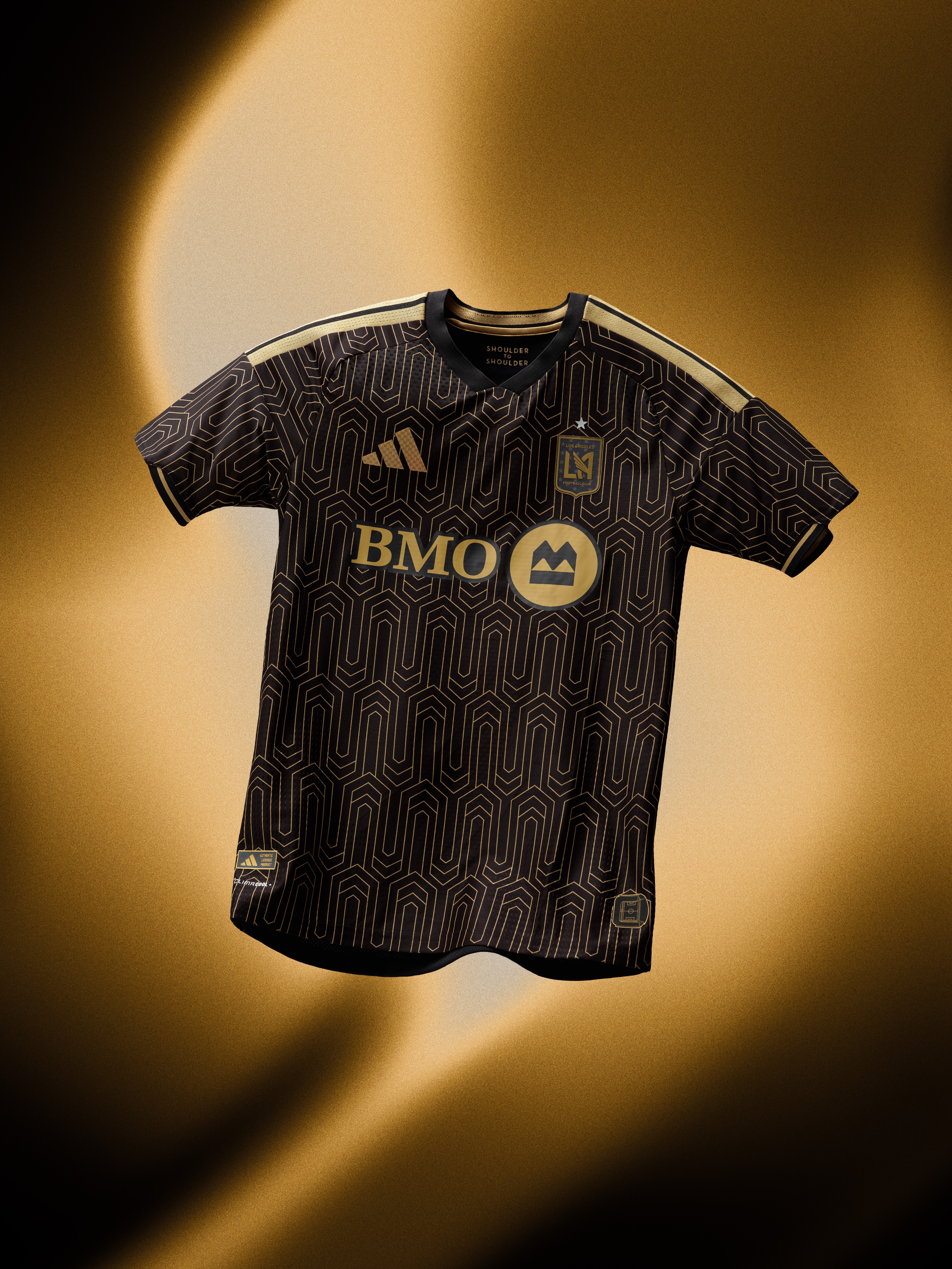 A black and gold soccer jersey with the BMO logo prominently displayed against a warm, golden background.