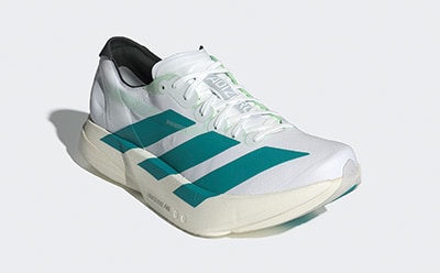 A pair of white and teal athletic shoes with a sleek, modern design against a plain white background.