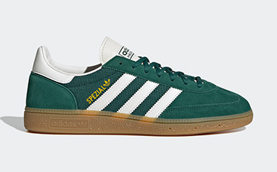 A pair of green and white Adidas Spezial sneakers with a gum sole, set against a plain white background.
