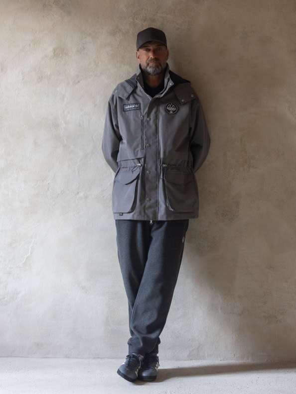 Jürgen Klopp models the adidas SPEZIAL collection, leaning casually against a beige concrete wall.