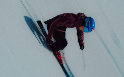 Skier skis downhill wearing the Terrex Adventure Wardrobe FW24 Collection