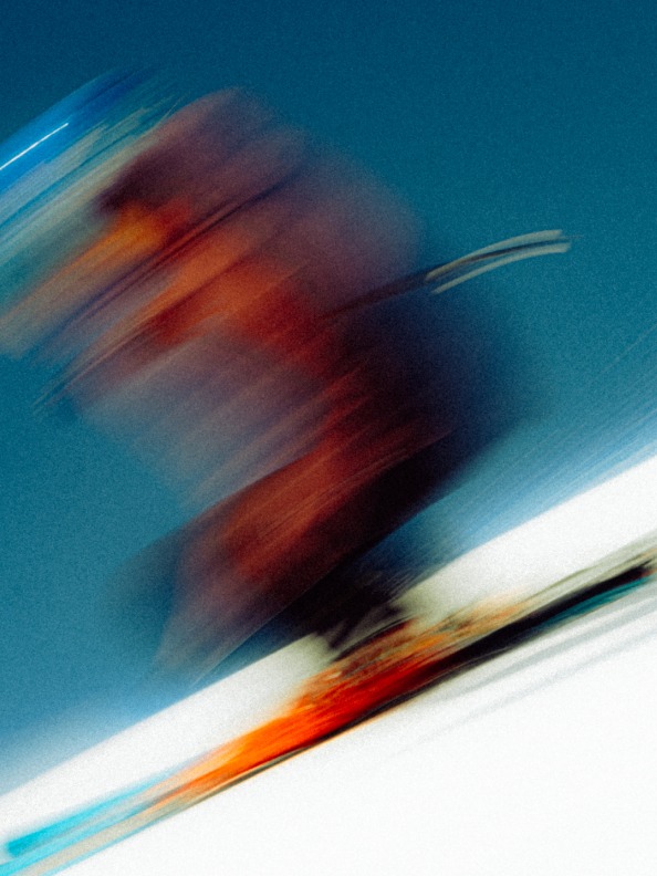 Blurred image of a skier going down the slopes wearing pieces from the Terrex Adventure Wardrobe FW24 Collection