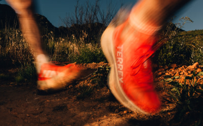 A close up action shot of a runner's feet, wearing the Agravic Speed Ultra.