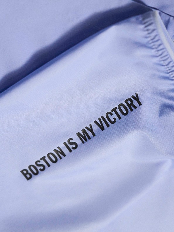 The image shows a close-up of a blue fabric or clothing item with the text "BOSTON IS MY VICTORY" printed on it.