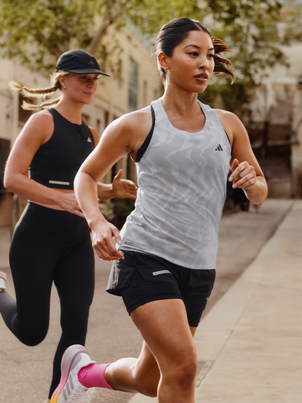 Image of woman running outdoors wearing adidas apparel and Ultraboost 5.