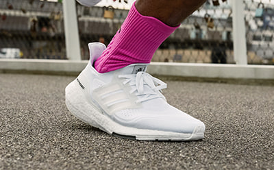 Image of foot running outdoors wearing Ultraboost Light.