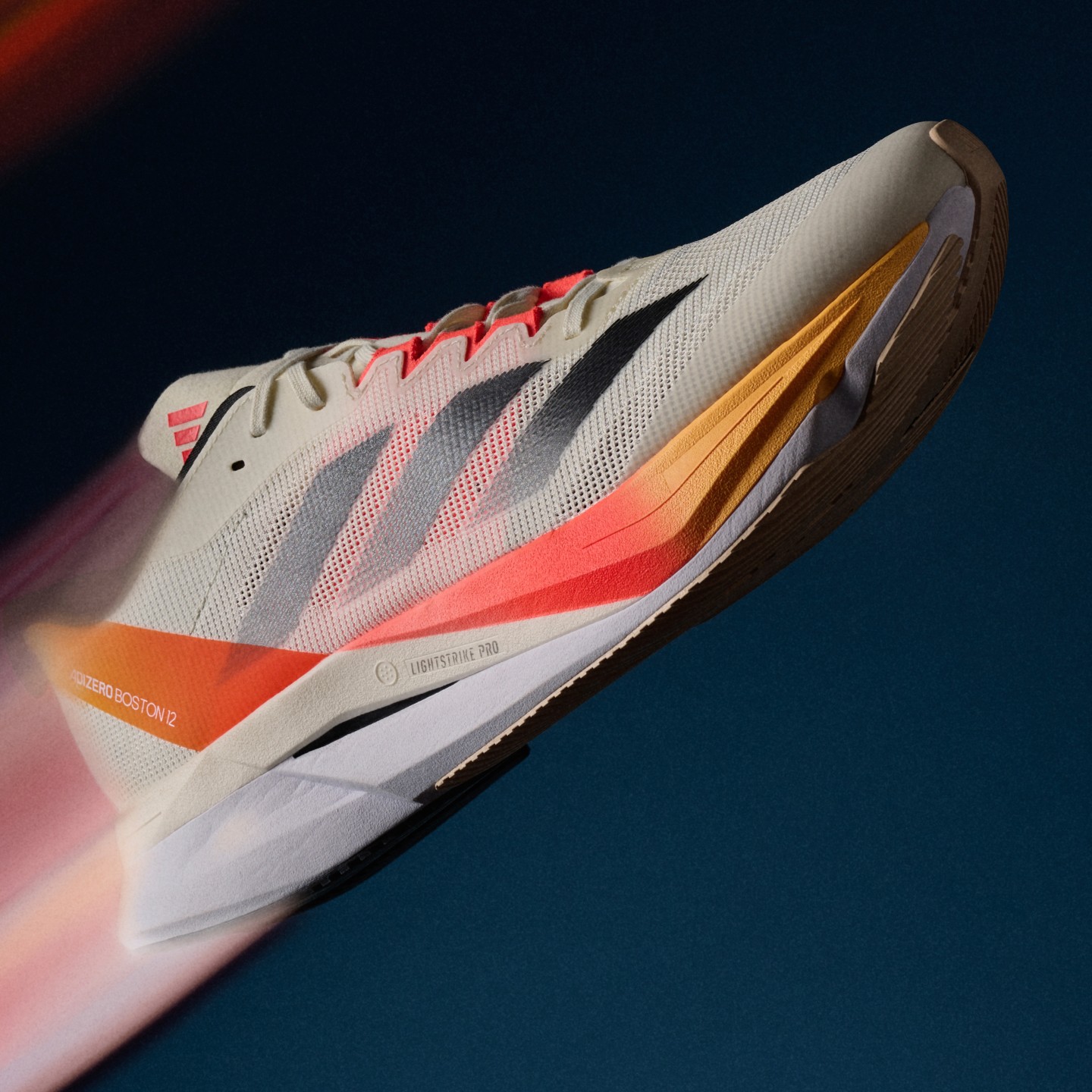 A close up of the new Adizero Boston 12, profiling the LIGHTSTRIKE PRO midsole that offers a cushioned ride.