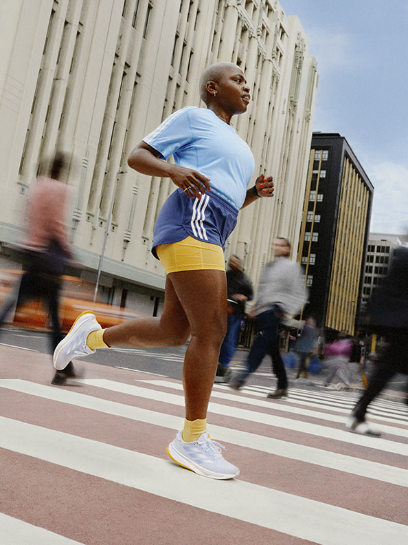 Image of a woman running outdoors wearing Supernovas.