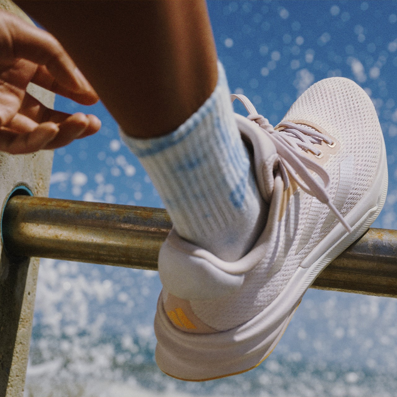 Close-up image of a woman lacing up her Supernovas.