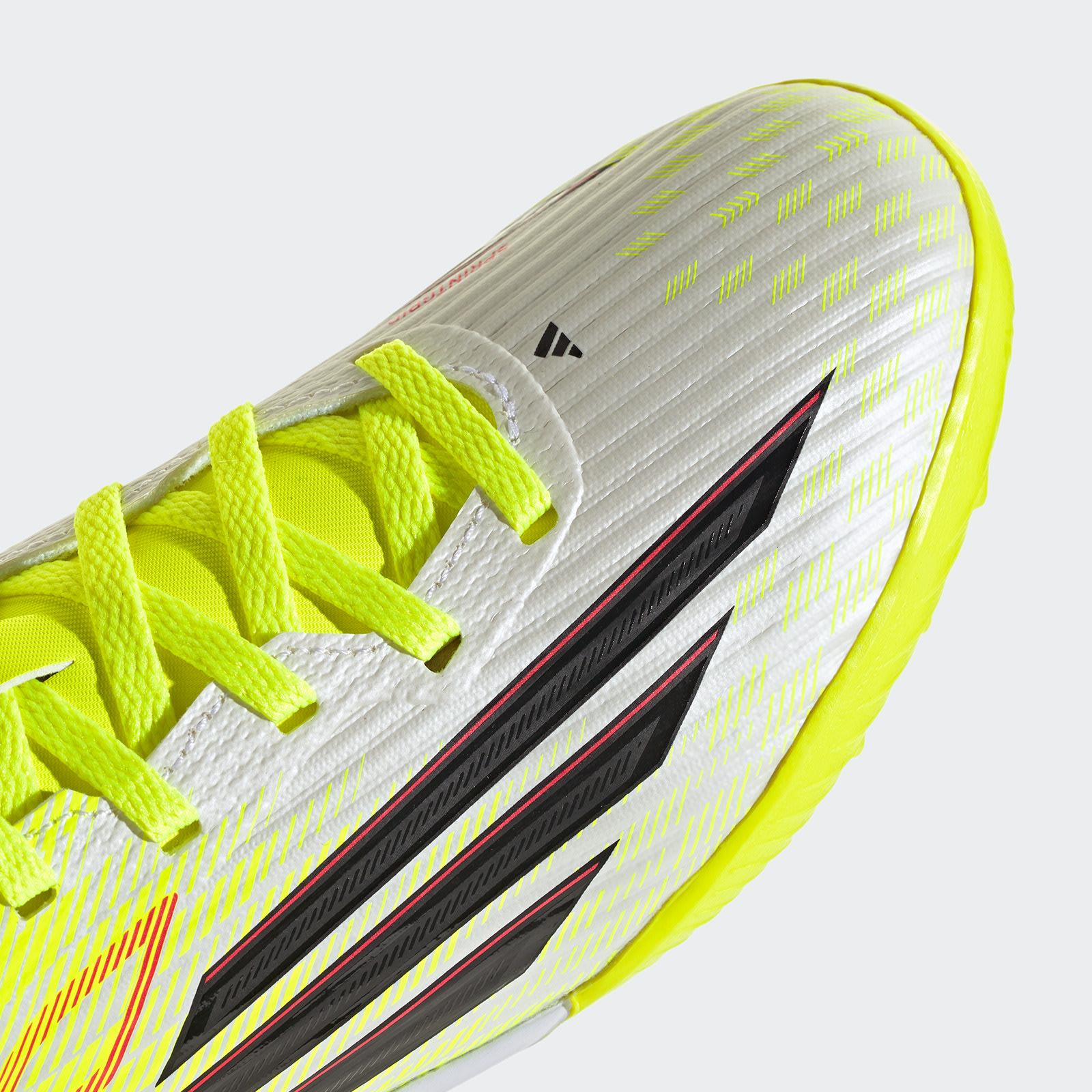 A close-up view of a vibrant yellow and white athletic shoe with bold black accents, set against a plain white background.