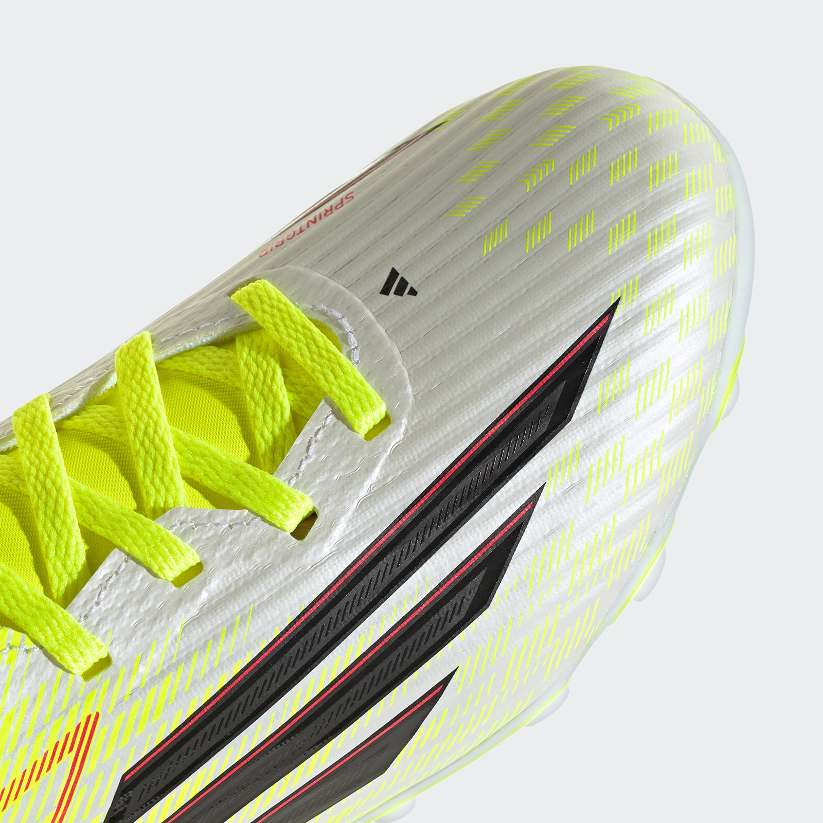 A close-up view of a vibrant, neon-yellow athletic shoe with distinctive black and red accents, set against a plain white background.