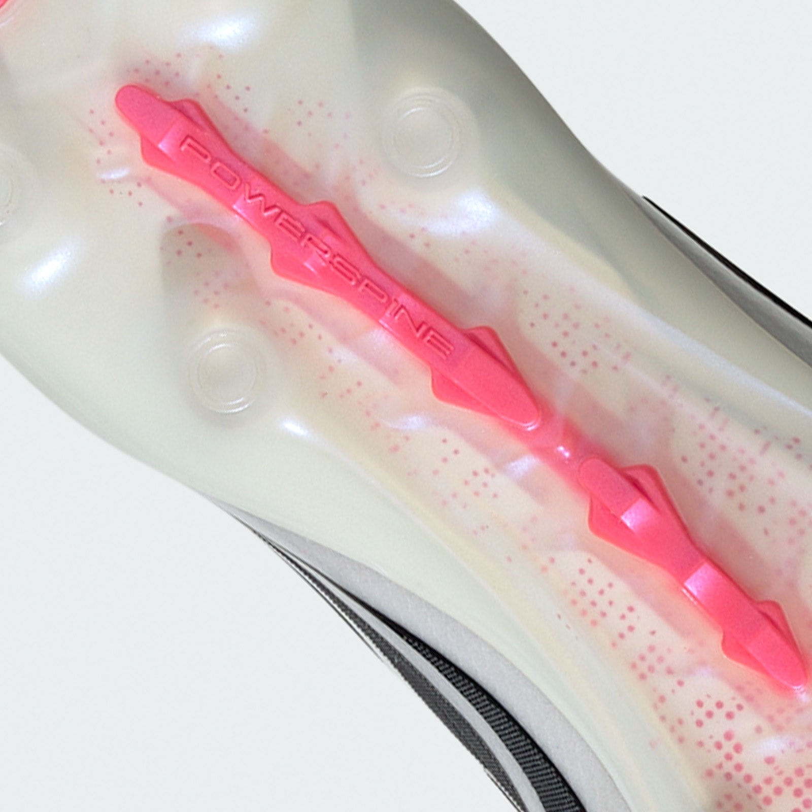 A bright pink plastic object, resembling a hair accessory or styling tool, is displayed against a blurred, light-colored background.