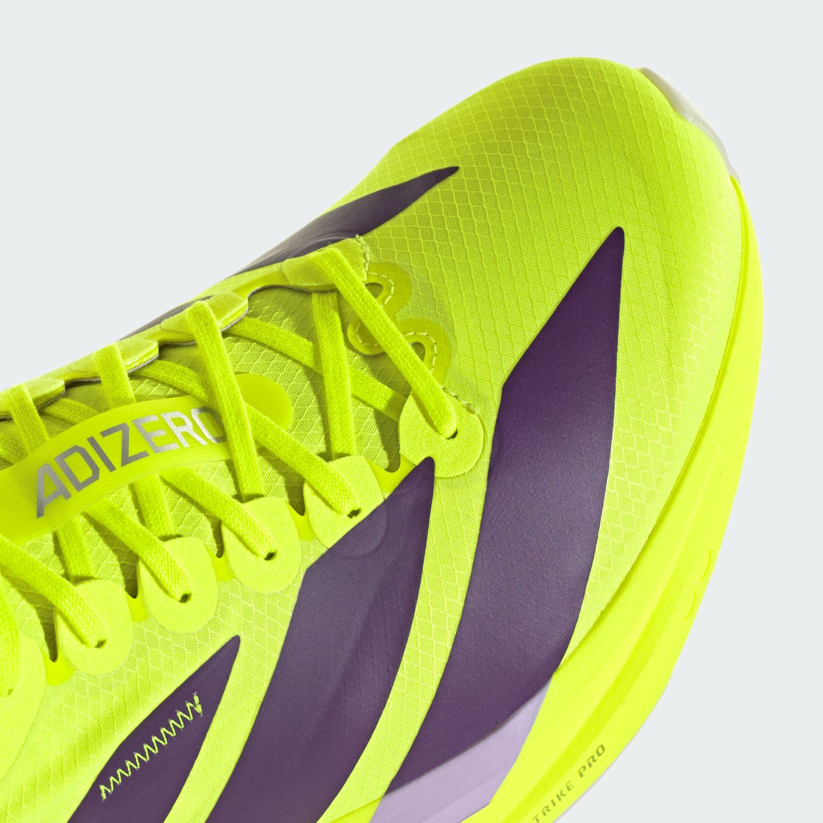 A vibrant neon yellow athletic shoe with purple accents, set against a plain white background.