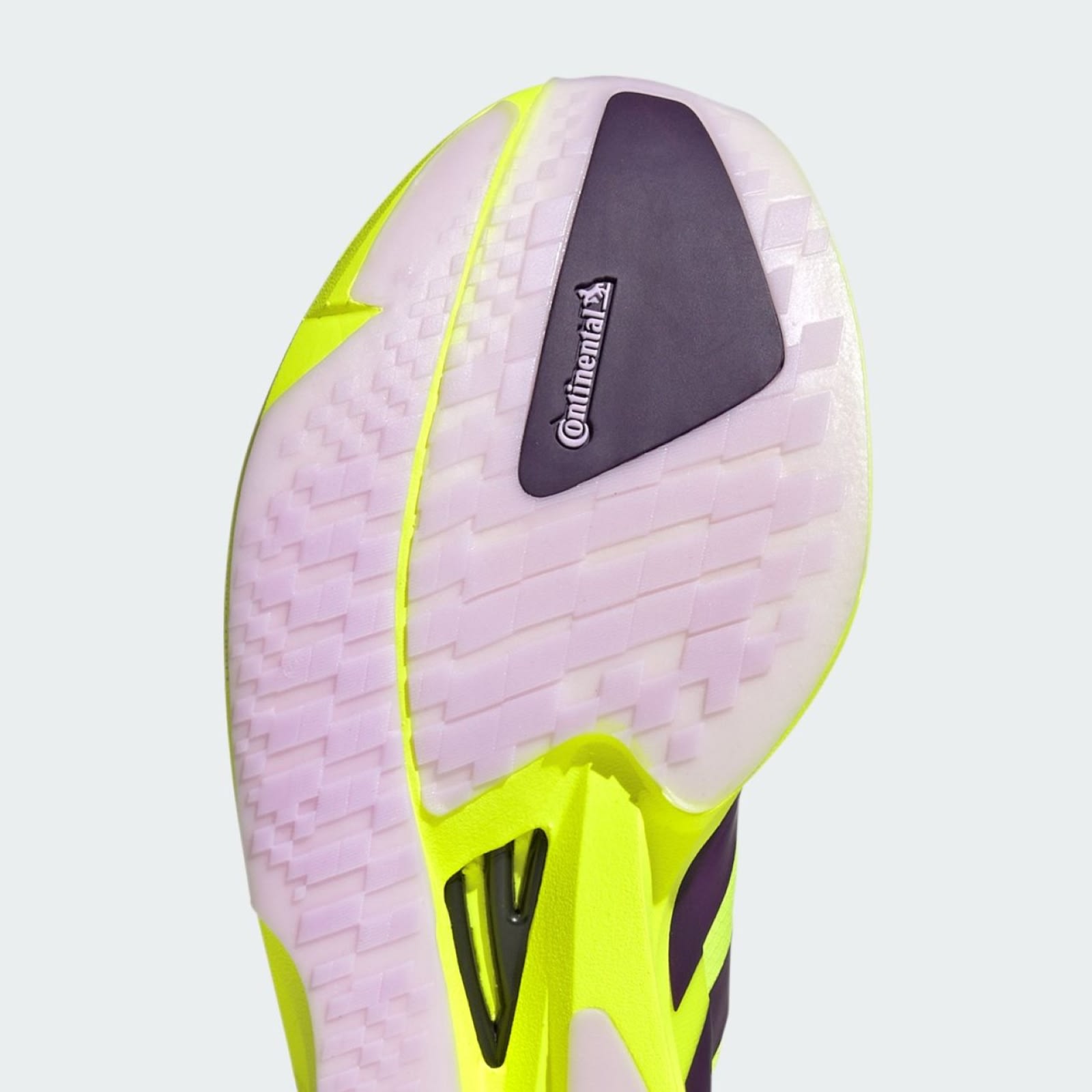 A vibrant, neon-colored athletic shoe with a textured, patterned upper and a prominent brand logo on the side.