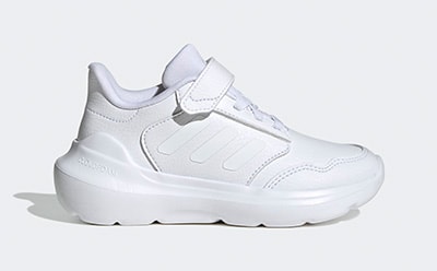 A pair of white, high-platform sneakers with a sleek, minimalist design stands against a plain, light-colored background.