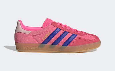 A pair of bright pink and purple Adidas sneakers with a gum sole, set against a plain white background.