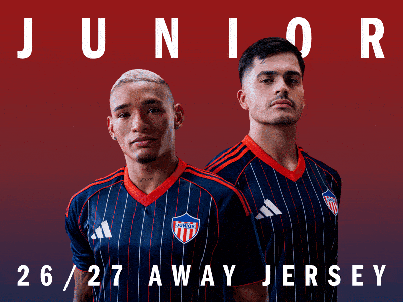 The image features two individuals wearing a navy blue and red soccer jersey with the word "JUNIOR" prominently displayed. The background is a solid red color, creating a bold and striking visual contrast.