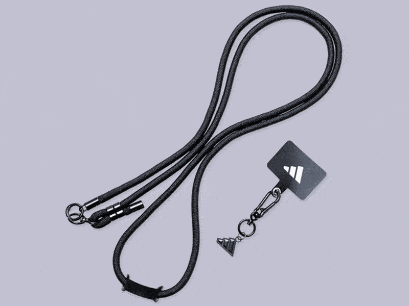 A black leather lanyard with a metal clasp and a small triangular charm attached to it, against a light gray background.