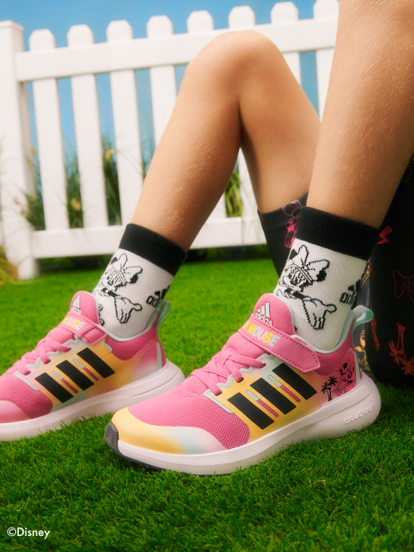 Focus on shoe on girls foot wearing adidas | Minnie Mouse collection