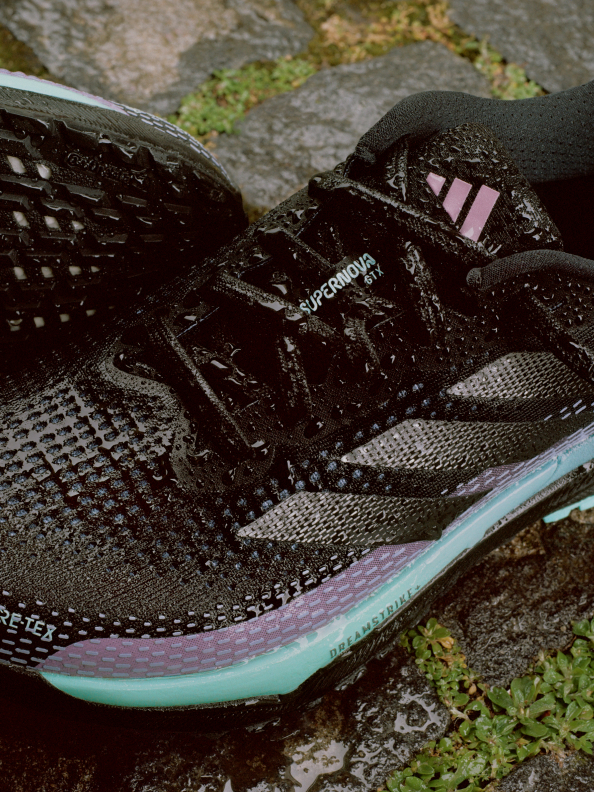 A close-up of the black, pink, and turquoise adidas Supernova GTX running shoe.