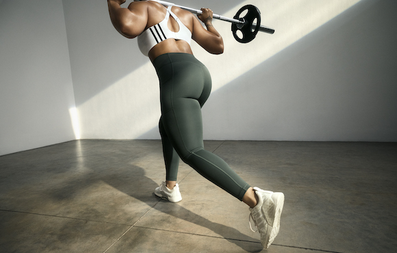 Female wearing the adidas OPTIME leggings while lifting weights