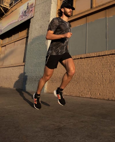 Image of a man running whilst wearing the adidas running collection