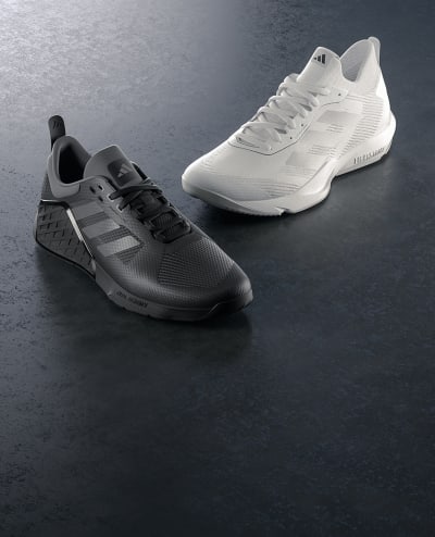 The image shows one Dropset 2 black trainer and one Rapidmove Advance white trainer at a three quarter angle.