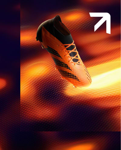 An adidas Predator football shoe touches the ground. It looks like a heatmap in hues of orange and red