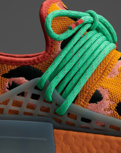 Side profile close-up of orange Hu NMD Animal Print shoe