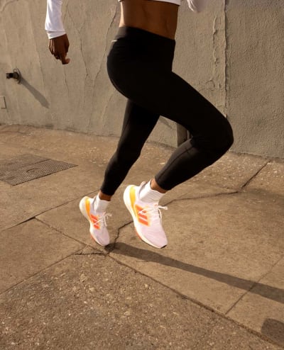 Close up image of a woman running whilst wearing the Ultraboost 22 shoe