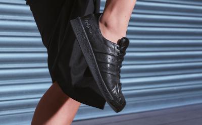 A closeup of a black adidas sneaker. 